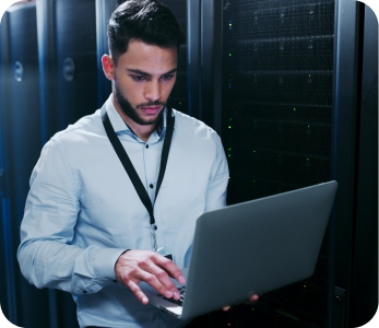 IT professional working beside server equipment