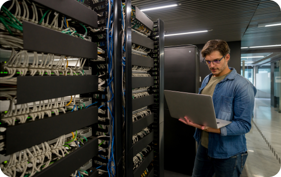 Technician reviewing network equipment in a rack