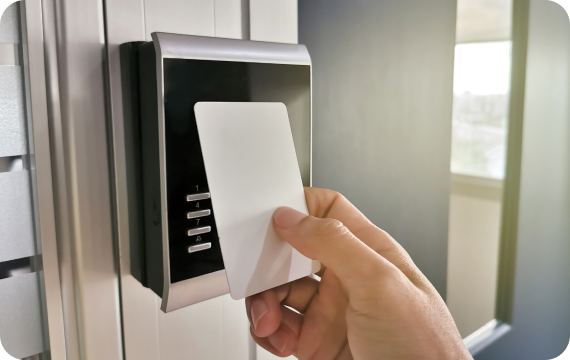 Person using a card at a door access reader
