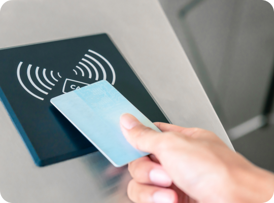 Person presenting a card to an access reader