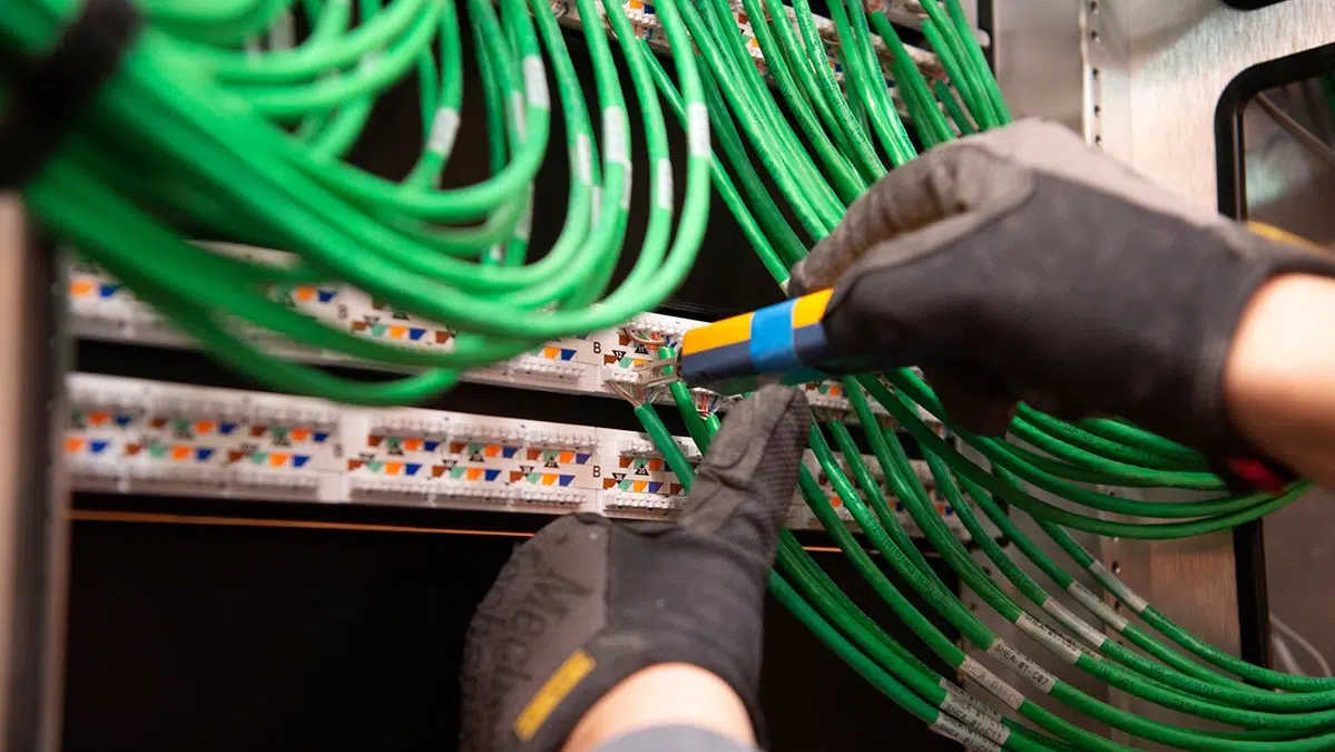 Hands working on organized low-voltage cabling